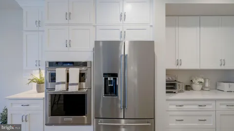 a kitchen with stainless steel appliances a refrigerator and cabinets