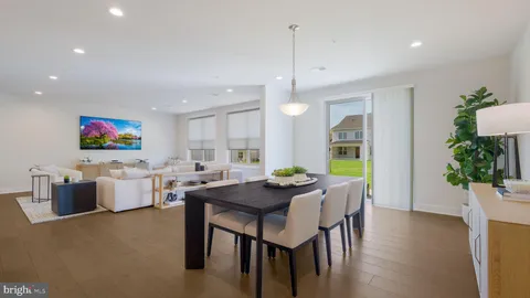 a dining room with furniture and wooden floor