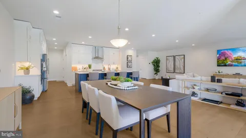 a view of a dining room with furniture and a kitchen