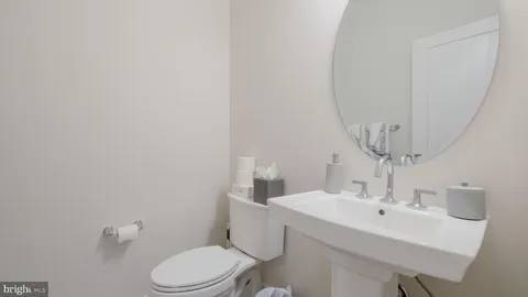 a bathroom with a sink a toilet and mirror