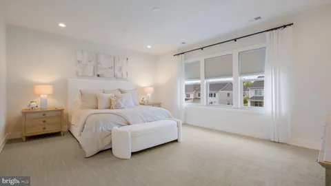 a spacious bedroom with a bed and a window