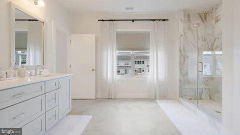 a bathroom with a shower sink and mirror