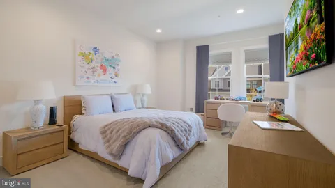 a bedroom with a bed and a painting on the wall