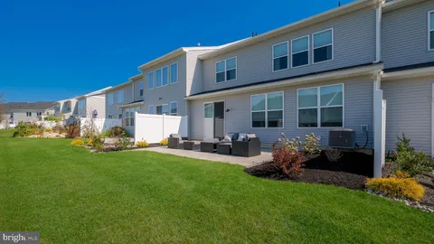 a front view of a house with patio and garden