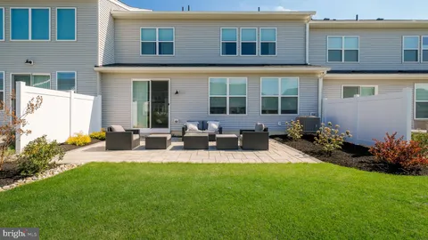 a view of a house with backyard sitting area and garden