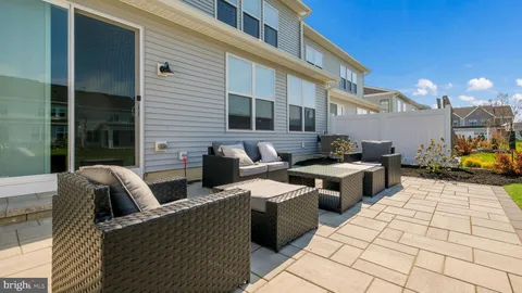 a view of a patio with couches chairs and potted plants