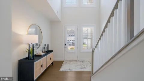 a view of an entryway with wooden floor