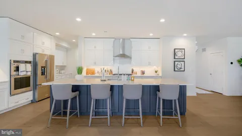 a large kitchen with a table and chairs