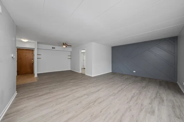 a view of a big room with wooden floor and closet