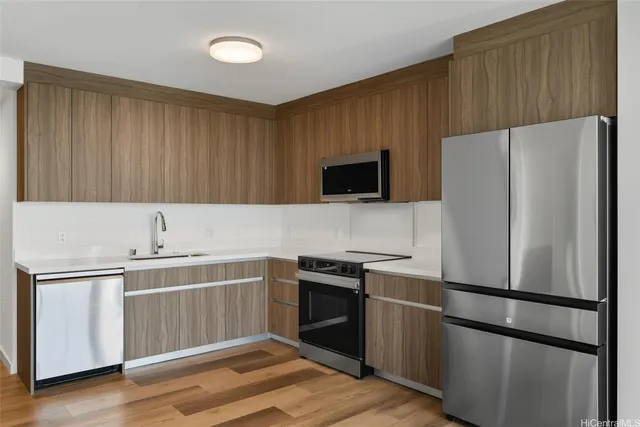 a kitchen with a refrigerator and a sink