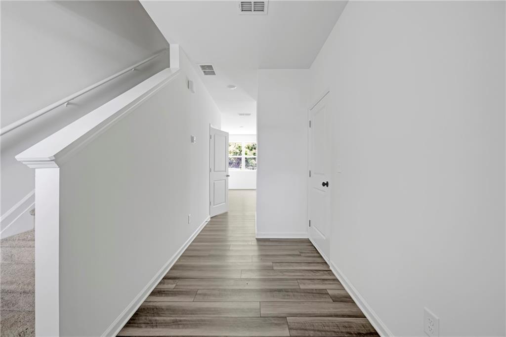 3568 Eagle Court Atlanta, GA 30331 - Photo 3 of 19 a view of a hallway with wooden floor and staircase