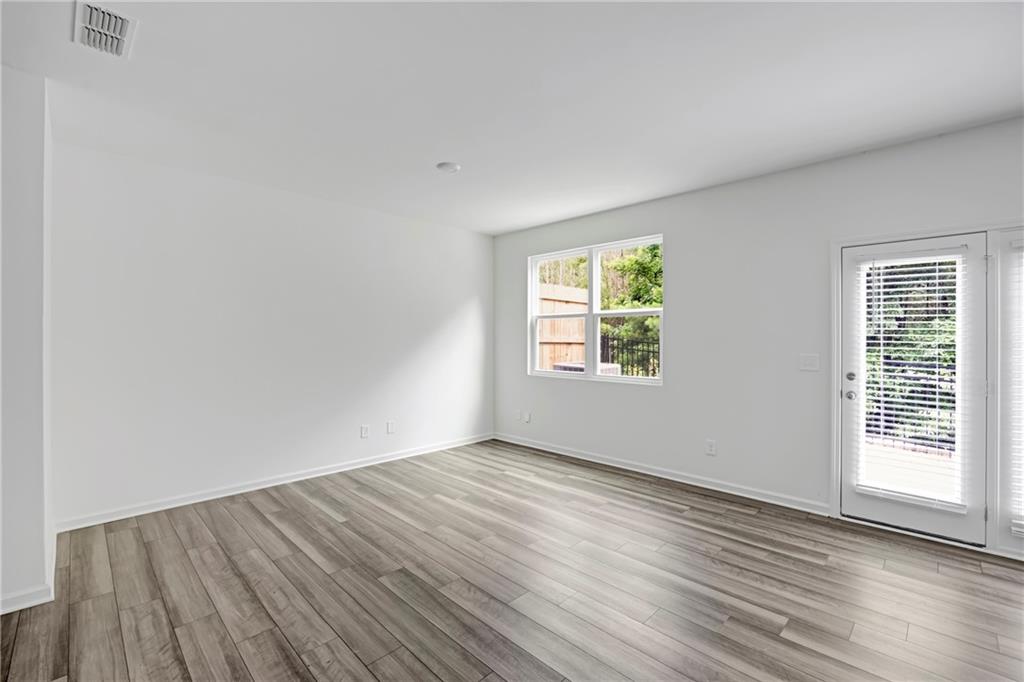 3568 Eagle Court Atlanta, GA 30331 - Photo 7 of 19 an empty room with wooden floor and windows