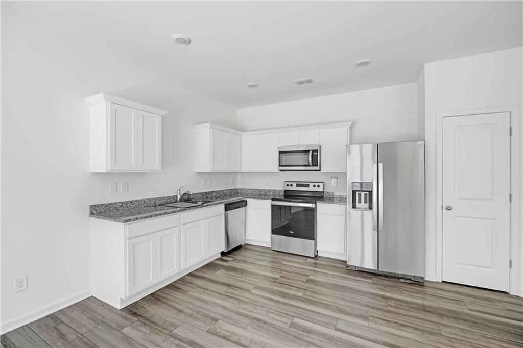 3568 Eagle Court Atlanta, GA 30331 - Photo 10 of 19 a kitchen with white cabinets and stainless steel appliances