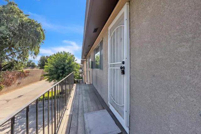 a view of a balcony with wooden floor and stairs
