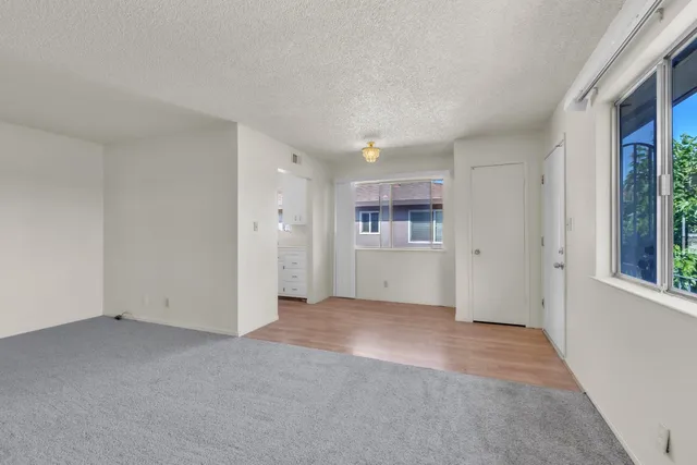 an empty room with a empty space and windows