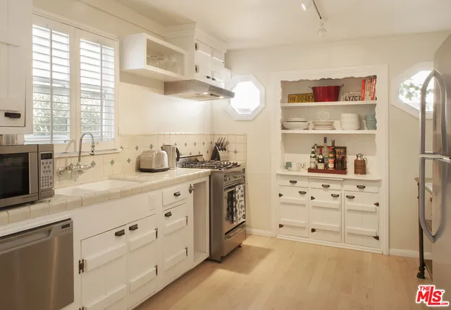 a spacious bathroom with a double vanity sink a mirror and a shower
