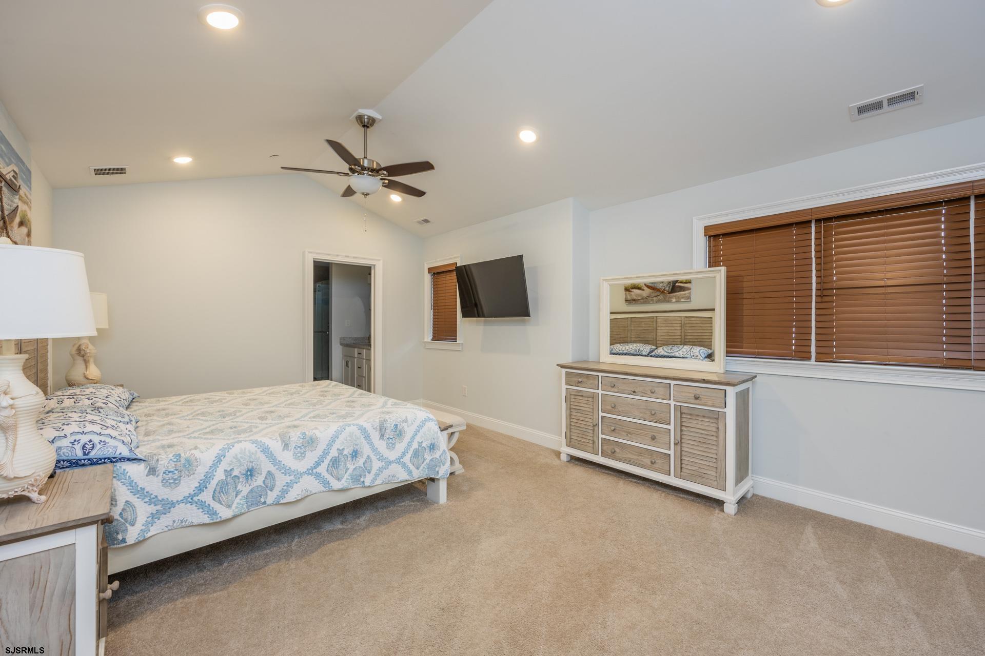 910 Ocean Avenue, Unit C Ocean City, NJ 08226 - Photo 13 of 36 a bedroom with a bed and a flat screen tv