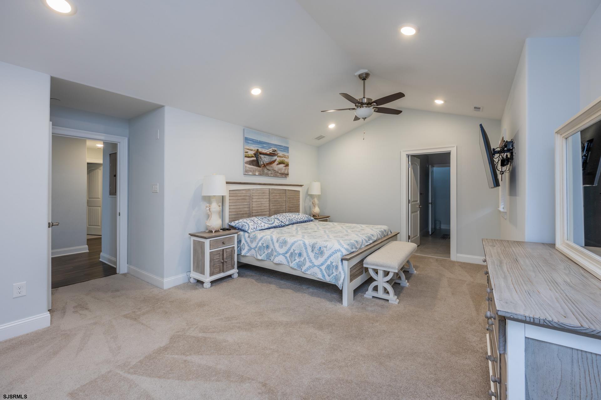 910 Ocean Avenue, Unit C Ocean City, NJ 08226 - Photo 14 of 36 a bedroom with a bed and a chandelier