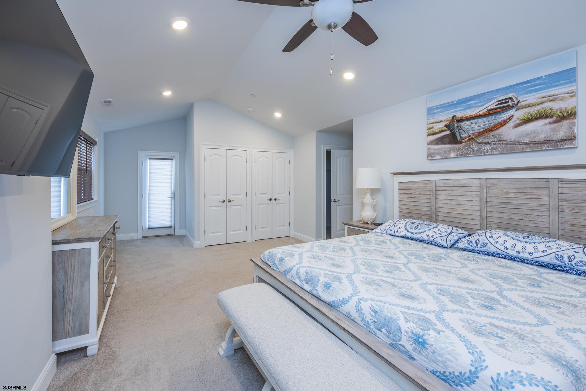 910 Ocean Avenue, Unit C Ocean City, NJ 08226 - Photo 15 of 36 a bedroom with a large bed and a chandelier