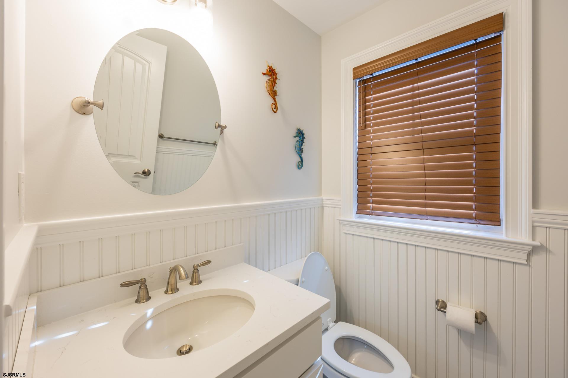 910 Ocean Avenue, Unit C Ocean City, NJ 08226 - Photo 18 of 36 a bathroom with a sink a toilet and a mirror