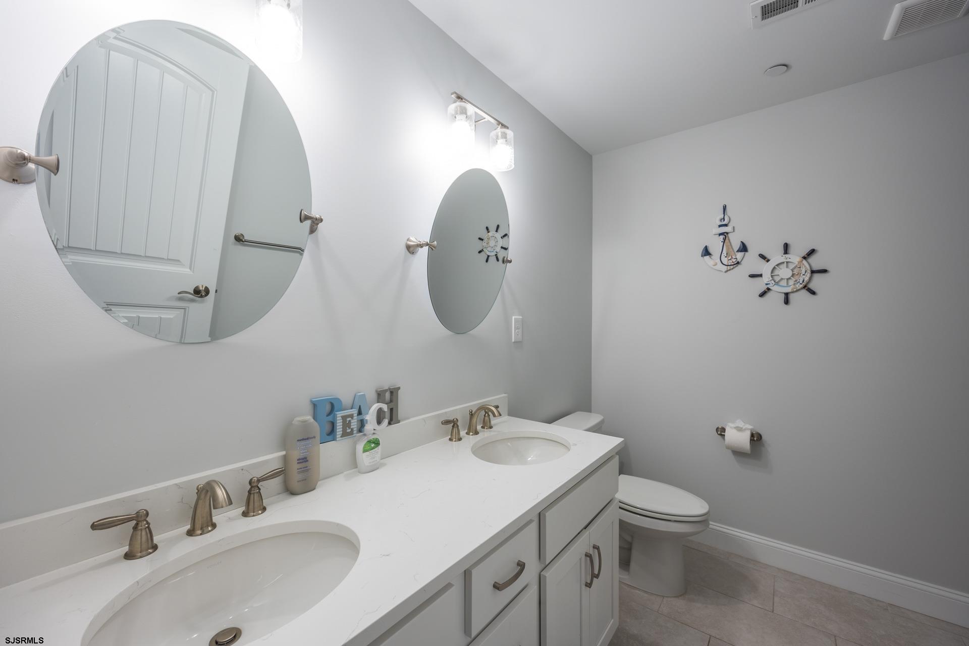 910 Ocean Avenue, Unit C Ocean City, NJ 08226 - Photo 19 of 36 a bathroom with a toilet sink and mirror