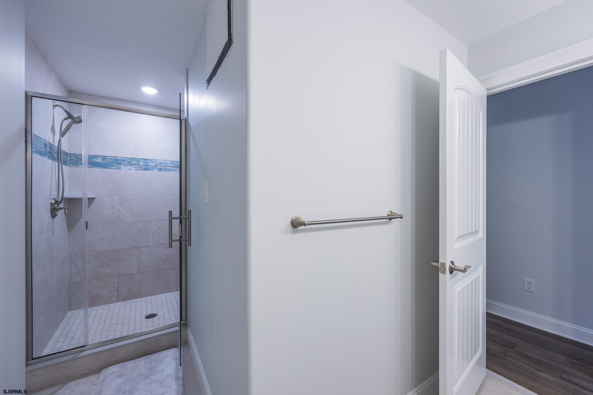 910 Ocean Avenue, Unit C Ocean City, NJ 08226 - Photo 20 of 36 a bathroom with a glass shower door