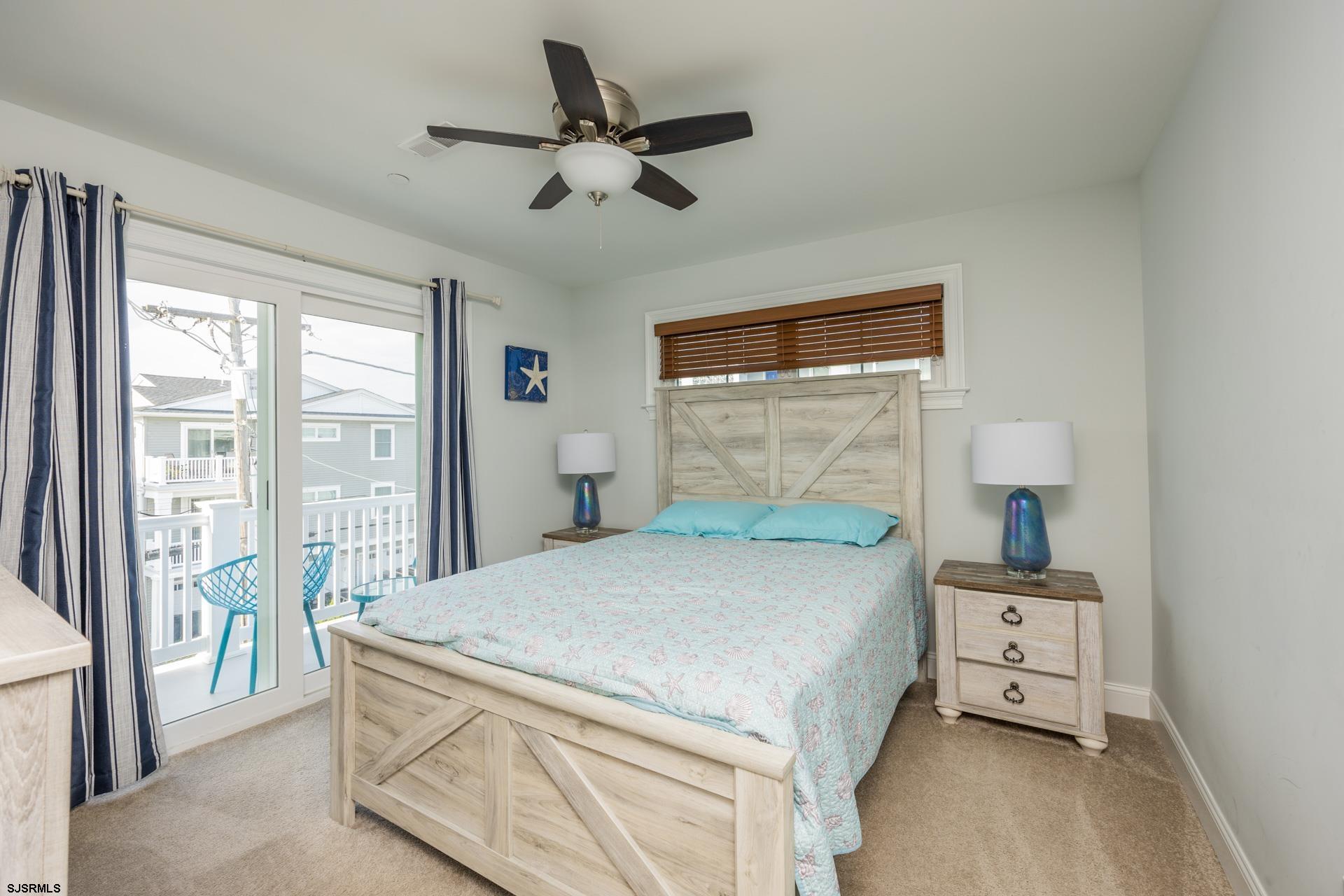 910 Ocean Avenue, Unit C Ocean City, NJ 08226 - Photo 21 of 36 a bedroom with a bed and a window