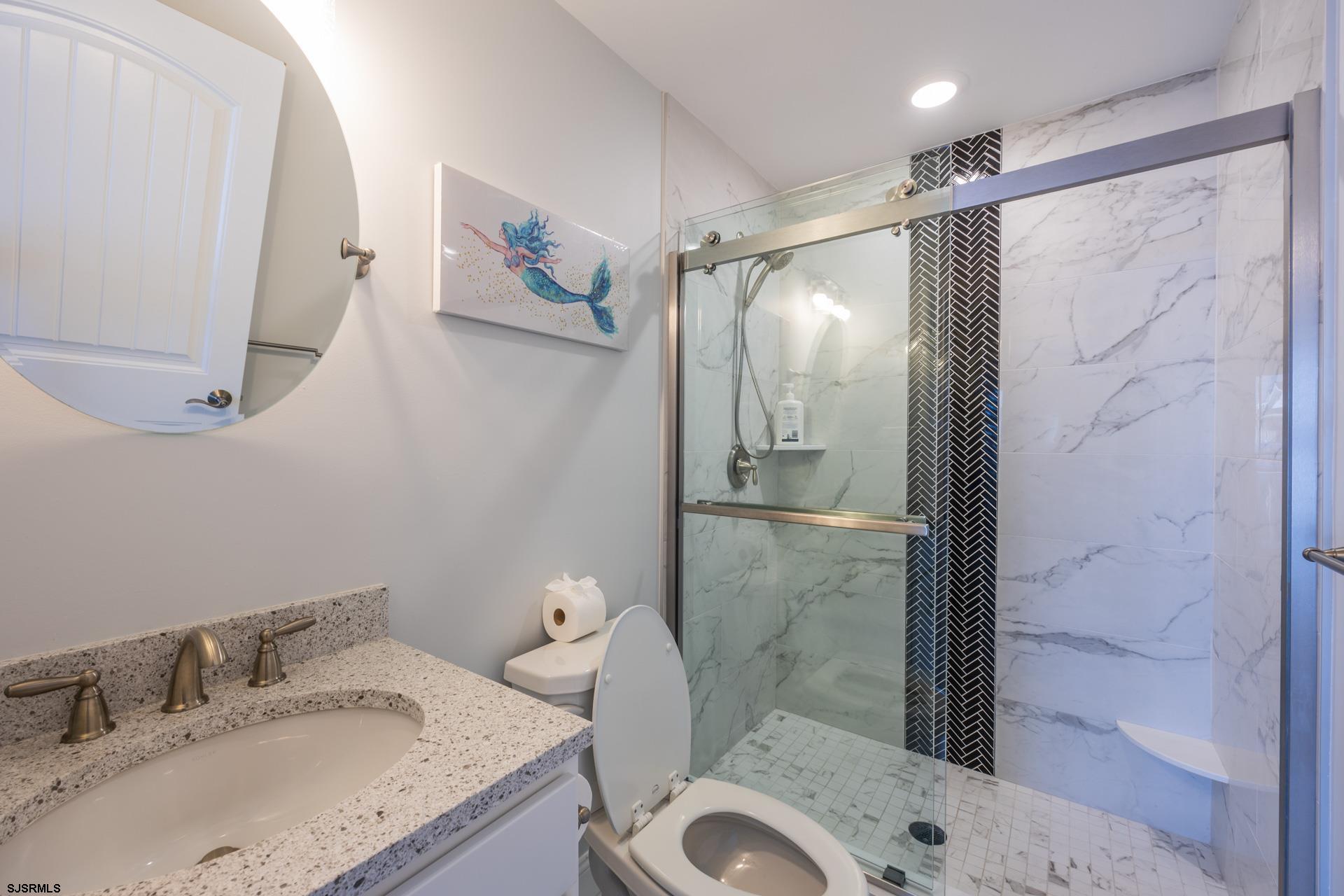 910 Ocean Avenue, Unit C Ocean City, NJ 08226 - Photo 23 of 36 a bathroom with a granite countertop sink toilet and shower