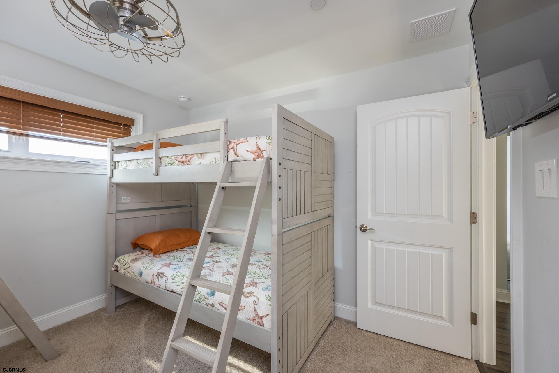 910 Ocean Avenue, Unit C Ocean City, NJ 08226 - Photo 28 of 36 a bedroom with a bed and a window