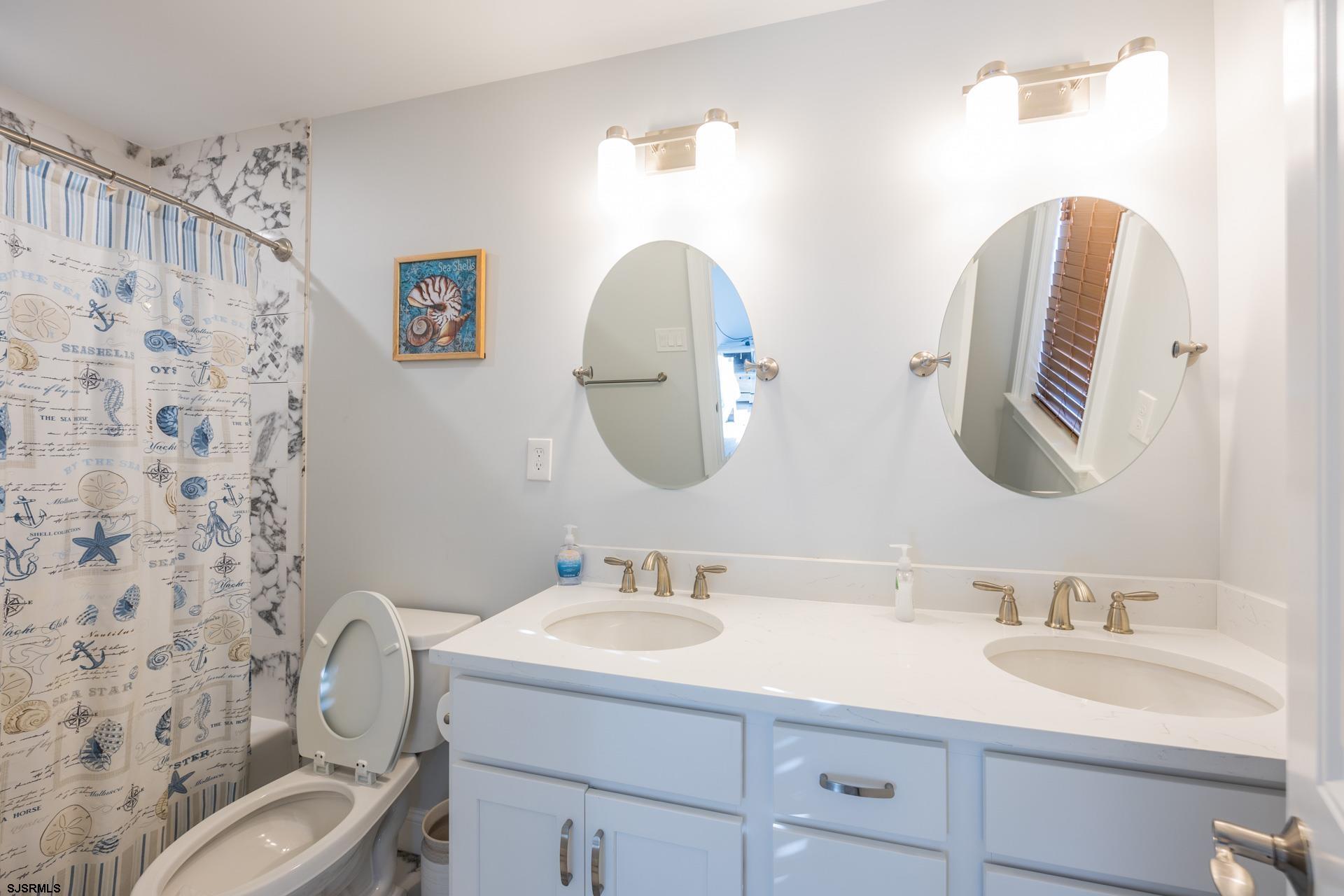 910 Ocean Avenue, Unit C Ocean City, NJ 08226 - Photo 32 of 36 a bathroom with a granite countertop sink and a mirror