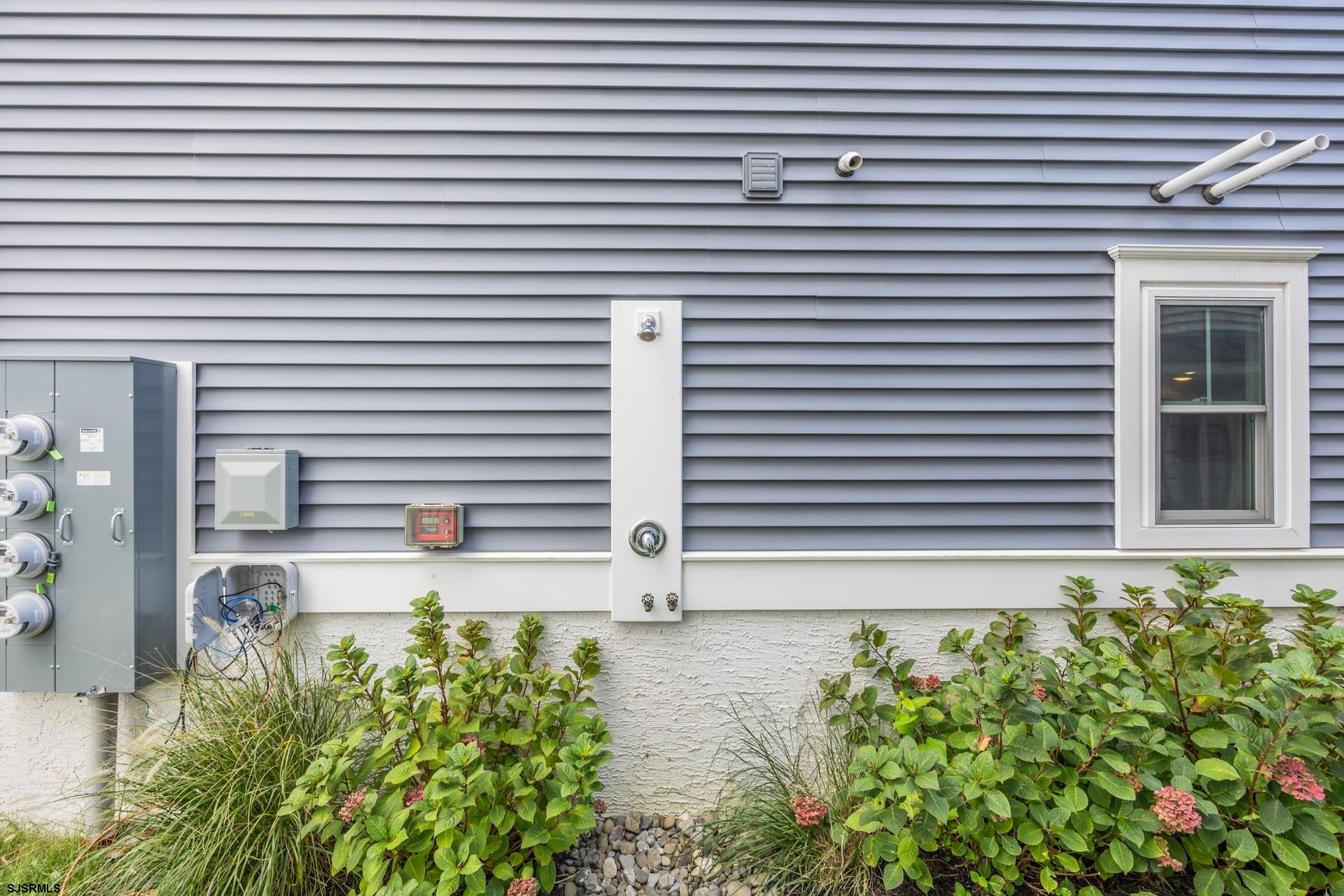 910 Ocean Avenue, Unit C Ocean City, NJ 08226 - Photo 35 of 36 a white house with a yard and a flower plants