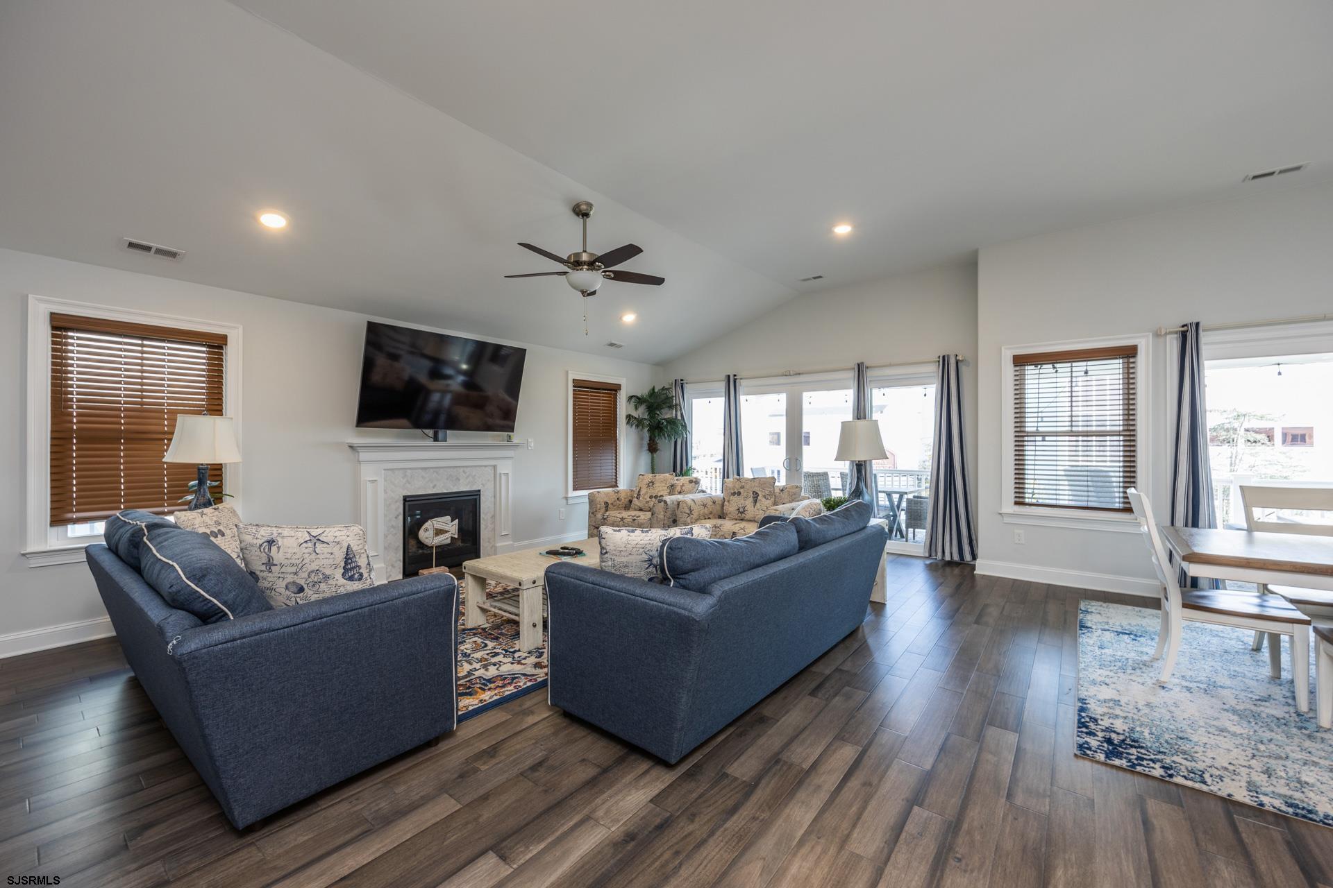 910 Ocean Avenue, Unit C Ocean City, NJ 08226 - Photo 4 of 36 a living room with furniture fireplace and a flat screen tv