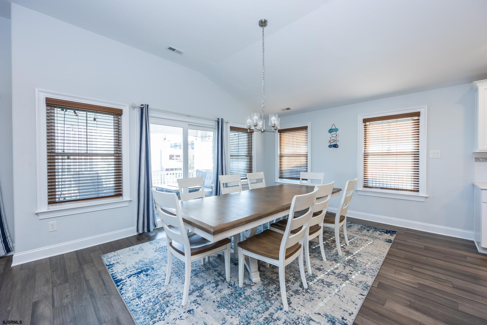 910 Ocean Avenue, Unit C Ocean City, NJ 08226 - Photo 7 of 36 a dining room with furniture a chandelier and wooden floor