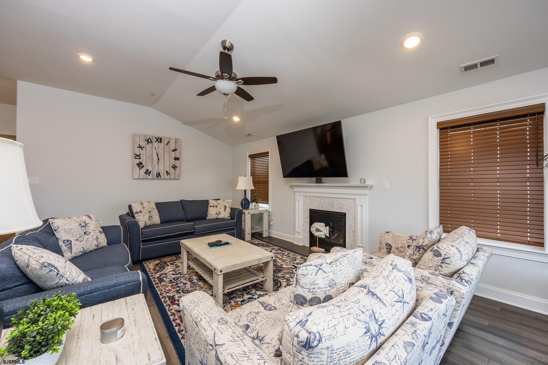 910 Ocean Avenue, Unit C Ocean City, NJ 08226 - Photo 9 of 36 a living room with furniture a fireplace and a flat screen tv