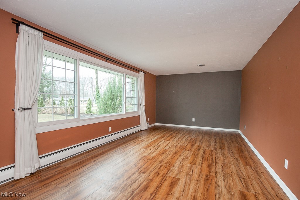 2969 Center Road Avon, OH 44011 - Photo 5 of 33 Unfurnished room featuring light hardwood / wood-style floors and a baseboard heating unit
