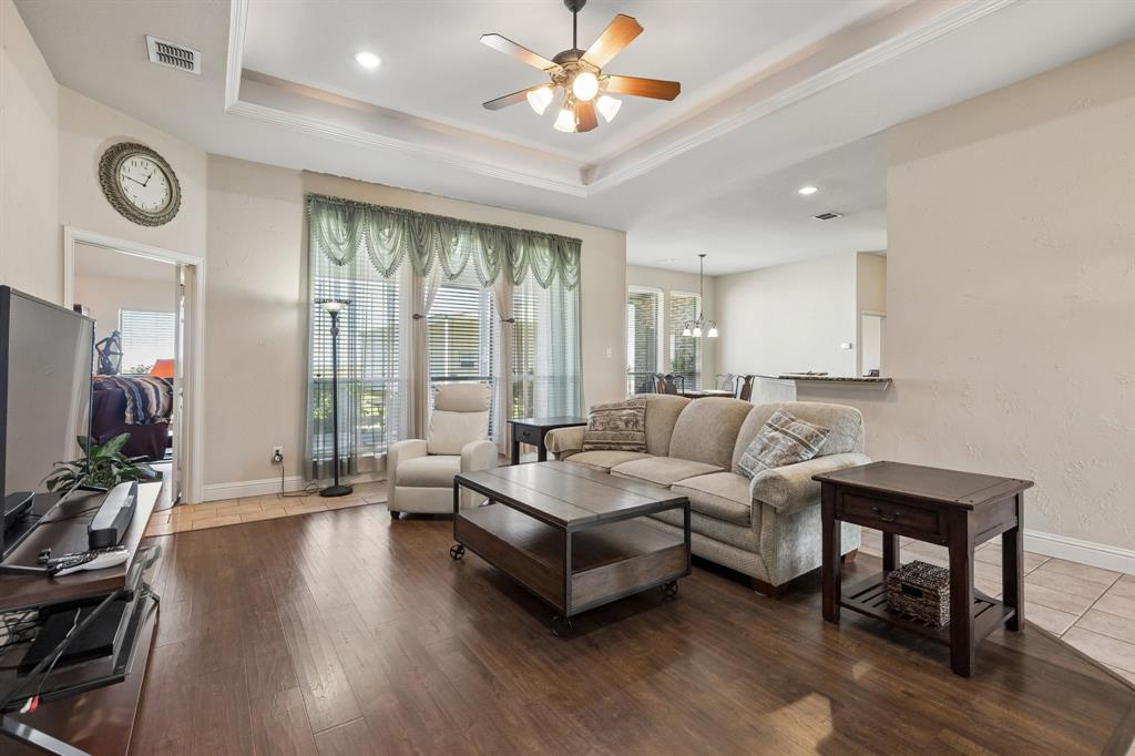 600 Lonesome Trail Haslet, TX 76052 - Photo 14 of 36 a living room with furniture a wooden floor and a large window