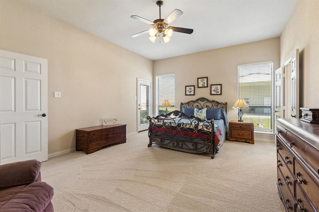 600 Lonesome Trail Haslet, TX 76052 - Photo 18 of 36 a spacious bedroom with a bed and a couch