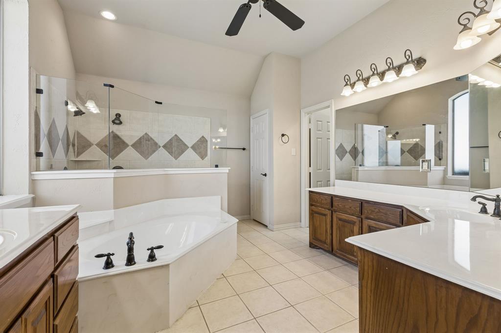 600 Lonesome Trail Haslet, TX 76052 - Photo 20 of 36 a bathroom with a tub sink and mirror
