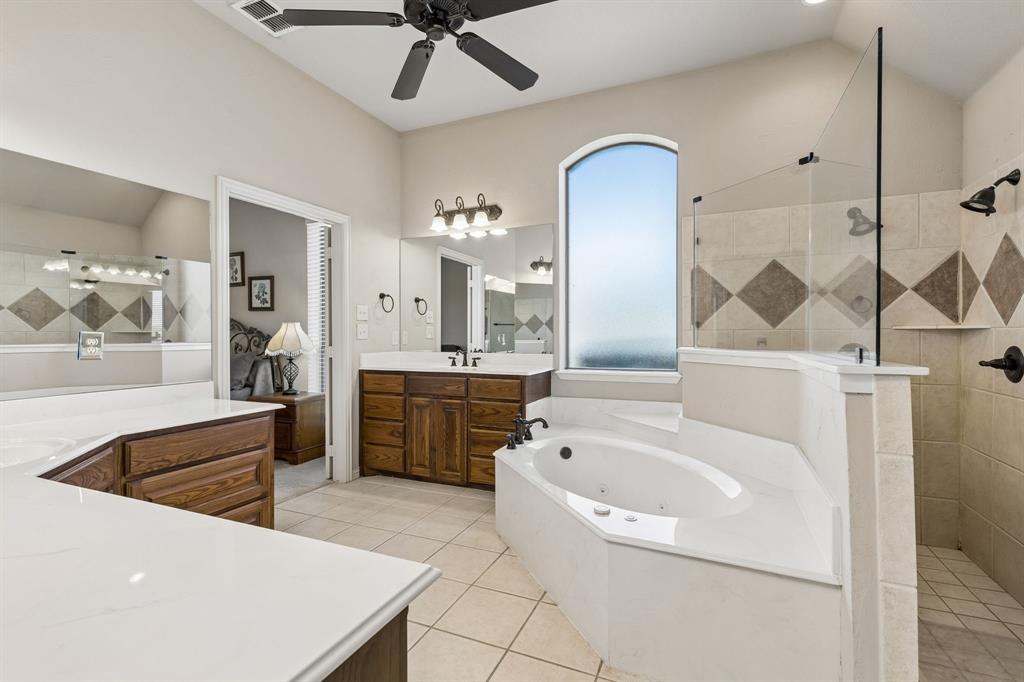 600 Lonesome Trail Haslet, TX 76052 - Photo 21 of 36 a bathroom with a tub a sink and mirror