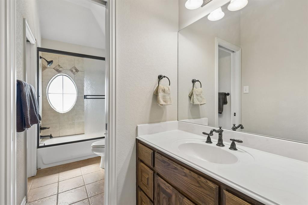 600 Lonesome Trail Haslet, TX 76052 - Photo 30 of 36 a bathroom with a granite countertop sink mirror and vanity
