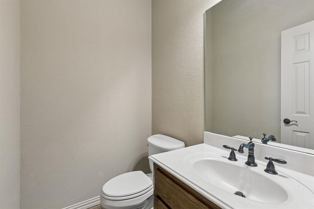 600 Lonesome Trail Haslet, TX 76052 - Photo 32 of 36 a bathroom with a sink a toilet and a mirror