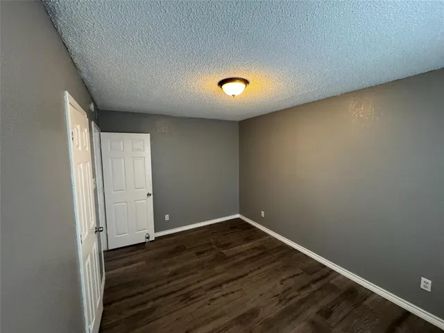 a view of room with wooden floor