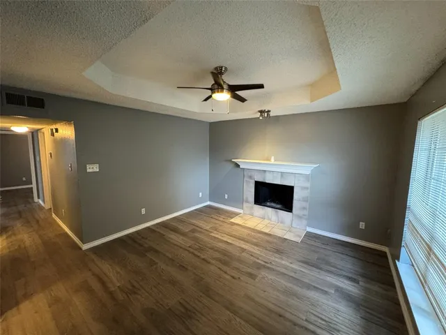 wooden floor in an empty room with a fireplace