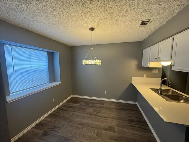 a room with wooden floor and window