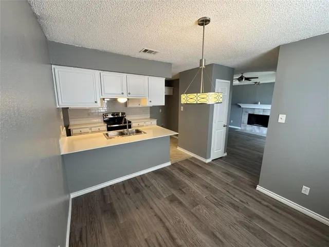 a view of a kitchen with electric appliances