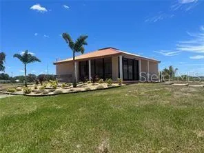 a view of a house with swimming pool lawn chairs and a yard