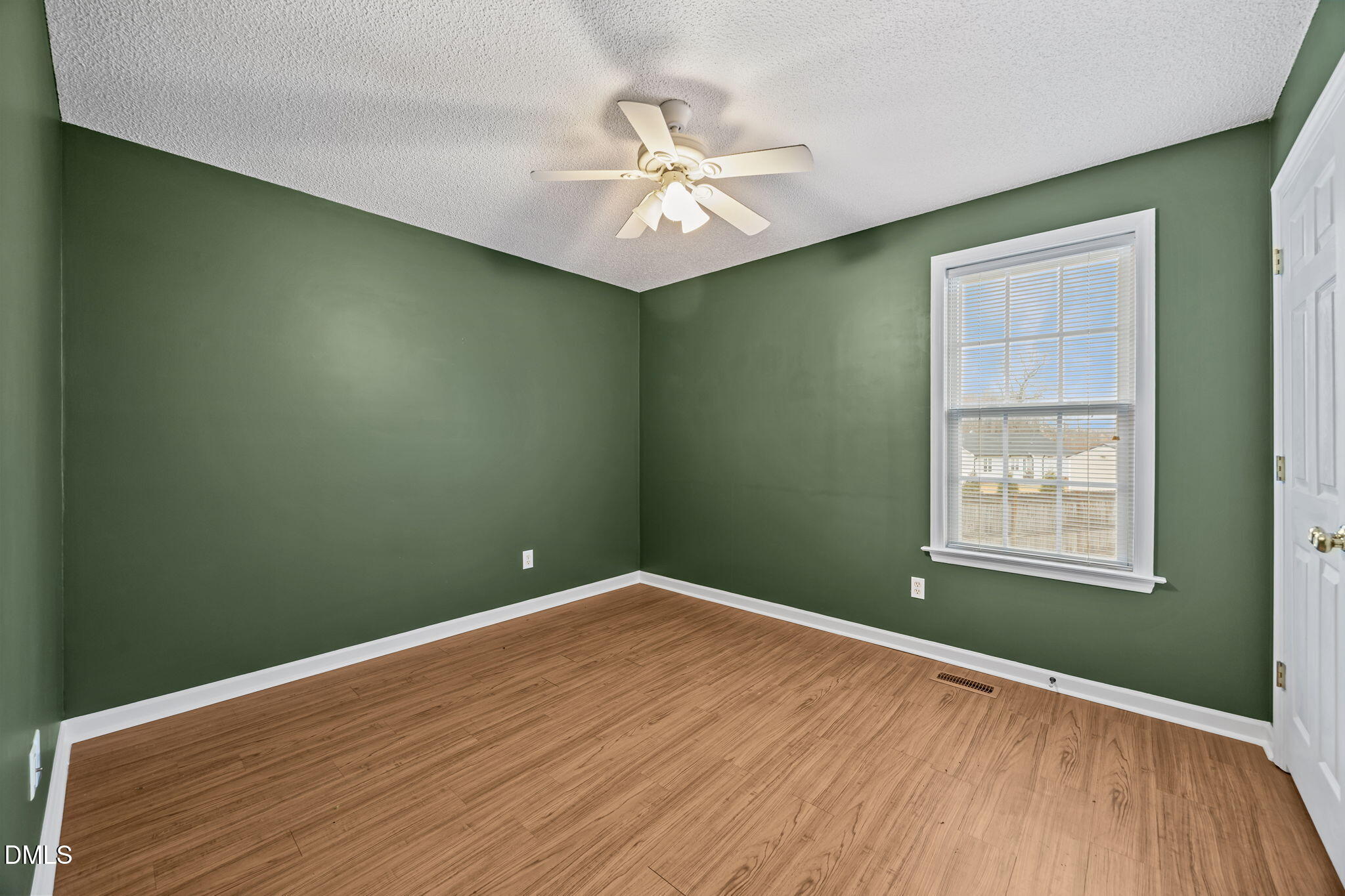 71 Rosa Circle Willow Spring, NC 27592 - Photo 19 of 31 an empty room with a window and a ceiling fan