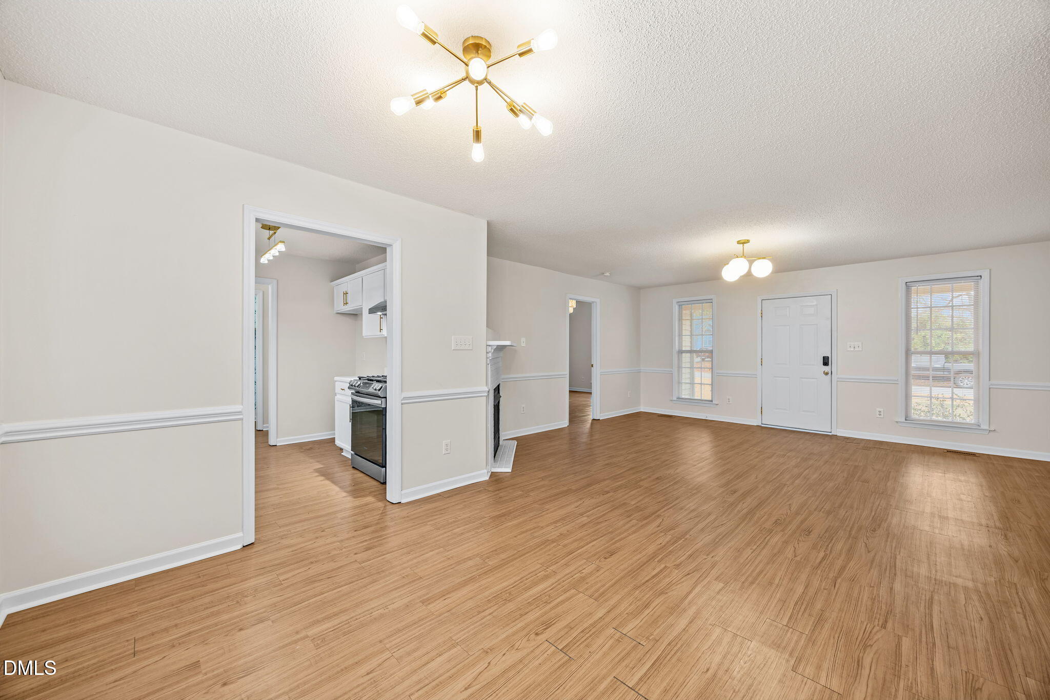 71 Rosa Circle Willow Spring, NC 27592 - Photo 9 of 31 a view of a livingroom with wooden floor and a ceiling fan