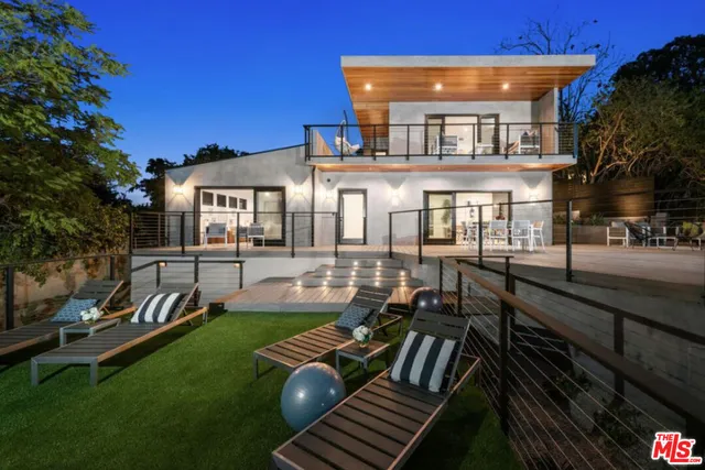 a view of a house with backyard porch and sitting area