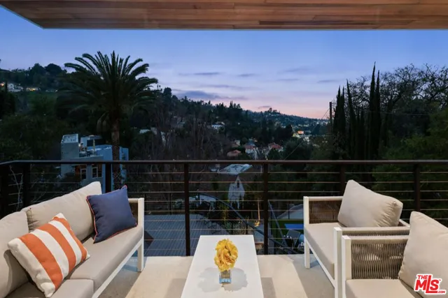 a view of a balcony with mountain view and wooden floor